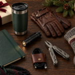 Practical Christmas gifts for him arranged on a wooden table